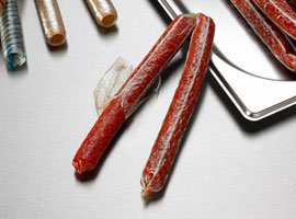 Dry cured snack sticks in cellulose casing