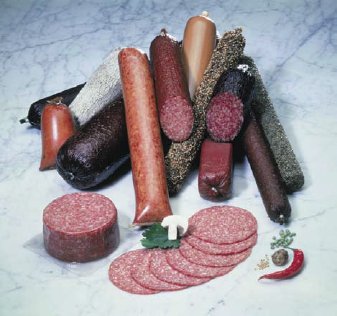 Assorted dry cured salami in fibrous casings with sliced salami and spices